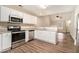 Modern kitchen with stainless steel appliances, granite countertops, and wood grain flooring at 132 Prity Ct, Mcdonough, GA 30253
