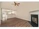 Open concept living room with fireplace open to the kitchen and outdoor access at 132 Prity Ct, Mcdonough, GA 30253