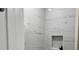 Elegant bathroom shower showcasing pristine marble tile, built in niche, and modern design at 1400 Bouldercrest Rd, Atlanta, GA 30316