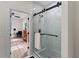 Bathroom featuring a glass shower with black trim and a view of a living space in the background at 1400 Bouldercrest Rd, Atlanta, GA 30316