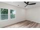 Bright bedroom features wood floor, a ceiling fan, and dual windows at 1400 Bouldercrest Rd, Atlanta, GA 30316