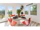 Bright breakfast nook with orange chairs, a round table, and doors to the backyard at 1400 Bouldercrest Rd, Atlanta, GA 30316