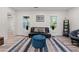 Living room showcasing natural light and wood-look floors with comfortable futon and decor at 1400 Bouldercrest Rd, Atlanta, GA 30316