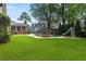 Large backyard features a luxurious pool with a slide, a fire pit area and lush green lawn at 1518 Cambridge Ave, Atlanta, GA 30337