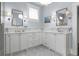 Elegant bathroom featuring marble countertops, ample cabinetry, and large mirrors with sconces at 1518 Cambridge Ave, Atlanta, GA 30337