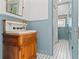 Charming bathroom with antique wood vanity, marble top, and black and white tile floors at 1518 Cambridge Ave, Atlanta, GA 30337