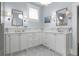 Bathroom featuring marble countertops, double vanity, and white cabinets at 1518 Cambridge Ave, Atlanta, GA 30337