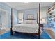 Serene bedroom with a four-poster bed, blue walls, and built-in bookshelves at 1518 Cambridge Ave, Atlanta, GA 30337