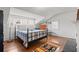 Sunny bedroom featuring wood floors, bright windows, and colorful rug at 1518 Cambridge Ave, Atlanta, GA 30337