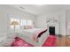 Cozy bedroom features a bright red rug, wooden floors, and a decorative fireplace at 1518 Cambridge Ave, Atlanta, GA 30337