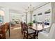 Elegant dining room with a chandelier, large windows, and views into the living room at 1518 Cambridge Ave, Atlanta, GA 30337