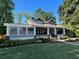 Charming two-story home with a covered front porch, well-manicured lawn and inviting curb appeal at 1518 Cambridge Ave, Atlanta, GA 30337