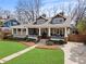Beautiful home featuring a covered porch, manicured landscaping, and a welcoming entrance at 1518 Cambridge Ave, Atlanta, GA 30337