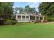 A well-maintained home featuring a lush green lawn, charming porch and mature trees at 1518 Cambridge Ave, Atlanta, GA 30337