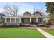 Charming two-story home with a covered porch, well-manicured lawn, and inviting curb appeal at 1518 Cambridge Ave, Atlanta, GA 30337