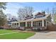 Beautiful two-story home with a large covered porch, manicured lawn, and stylish architectural details at 1518 Cambridge Ave, Atlanta, GA 30337
