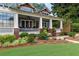 Beautiful home boasting a spacious front porch with white columns and colorful flower beds at 1518 Cambridge Ave, Atlanta, GA 30337