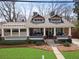 Inviting two-story home with a charming front porch and a well-manicured lawn at 1518 Cambridge Ave, Atlanta, GA 30337