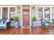 Inviting front porch with hardwood floors, comfortable seating, plants, and College Park Est. 1896 doormat at 1518 Cambridge Ave, Atlanta, GA 30337