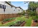 Lush backyard garden featuring a wooden fence and raised garden beds at 1518 Cambridge Ave, Atlanta, GA 30337