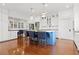 Open kitchen design with a blue island, marble countertops, and stainless steel appliances at 1518 Cambridge Ave, Atlanta, GA 30337