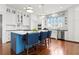 Spacious kitchen with blue center island, marble countertop, stainless appliances, and wooden floors at 1518 Cambridge Ave, Atlanta, GA 30337
