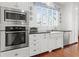Modern kitchen includes stainless steel appliances, a farmhouse sink, and a built-in microwave at 1518 Cambridge Ave, Atlanta, GA 30337