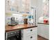 Bright kitchen with glass cabinets, white subway tile, and wooden countertop and under-cabinet lighting at 1518 Cambridge Ave, Atlanta, GA 30337