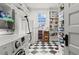 Well-organized laundry room featuring a washer, dryer, shelving, and storage at 1518 Cambridge Ave, Atlanta, GA 30337
