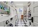Well-organized laundry room with checkerboard flooring, shelving, and a modern washer and dryer at 1518 Cambridge Ave, Atlanta, GA 30337