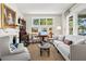 Cozy living room with neutral tones, a fireplace, and large windows offering natural light at 1518 Cambridge Ave, Atlanta, GA 30337