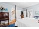 Main bedroom with four-poster bed, walk in closet, hardwood floors, and view of stairs at 1518 Cambridge Ave, Atlanta, GA 30337