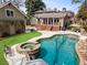 Beautiful backyard pool and spa with a deck for entertaining and lush landscaping at 1518 Cambridge Ave, Atlanta, GA 30337