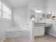 Bright bathroom featuring a soaking tub and granite countertops at 2304 Stancrest Ln, Lawrenceville, GA 30044