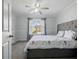 Bedroom featuring a bed with a grey headboard, a ceiling fan, and a window at 2304 Stancrest Ln, Lawrenceville, GA 30044