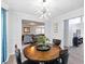 Cozy dining room features modern chandelier, wood floors, and access to living room at 2304 Stancrest Ln, Lawrenceville, GA 30044
