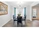 Elegant dining room boasts stylish lighting, hardwood flooring and neutral walls at 2304 Stancrest Ln, Lawrenceville, GA 30044