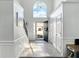Bright foyer boasts soaring ceilings, tile flooring, staircase, and a modern light fixture at 2304 Stancrest Ln, Lawrenceville, GA 30044