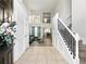 Inviting foyer features high ceilings, tile flooring, staircase, and views into the living and dining areas at 2304 Stancrest Ln, Lawrenceville, GA 30044