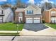 Charming two-story home with a well-manicured lawn, two-car garage, and lovely curb appeal at 2304 Stancrest Ln, Lawrenceville, GA 30044