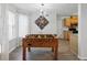 A well-lit game room featuring a classic foosball table, adjacent to the kitchen at 2304 Stancrest Ln, Lawrenceville, GA 30044