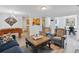 Open-concept living area with hardwood floors, stylish furnishings, and a view into the kitchen and dining area at 2304 Stancrest Ln, Lawrenceville, GA 30044