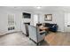 Bright living room with gray chairs, a blue sofa, and a decorative coffee table set on wood floors at 2304 Stancrest Ln, Lawrenceville, GA 30044