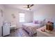 Bright bedroom with a white bed frame, accented by a colorful bedspread and decor at 4285 Hurt Bridge Rd, Cumming, GA 30028