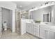 Bathroom featuring double vanity, tile floor, framed mirrors, and glass enclosed shower at 4362 White Spruce Aly, Doraville, GA 30360