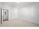 Neutral carpeted bedroom features an ensuite bathroom and double-door closet at 4362 White Spruce Aly, Doraville, GA 30360