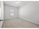 Bright bedroom with a large window and neutral carpet, creating a serene and comfortable space at 4362 White Spruce Aly, Doraville, GA 30360