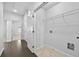 Hallway with hardwood floors leads to a laundry room and additional rooms, offering ample space at 4362 White Spruce Aly, Doraville, GA 30360