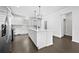 Modern white kitchen featuring stainless steel appliances, a large center island, and ample countertop space at 4362 White Spruce Aly, Doraville, GA 30360