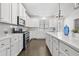 Stylish kitchen featuring white cabinets, stainless steel appliances, a double oven, and a large center island at 4362 White Spruce Aly, Doraville, GA 30360